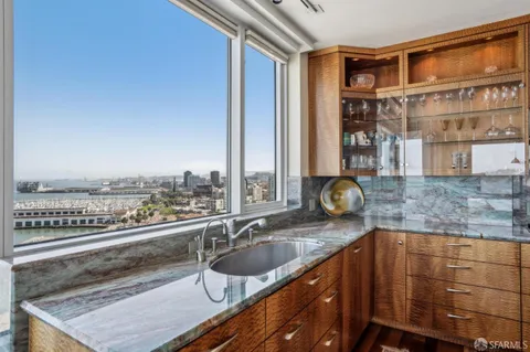 a bathroom with a granite countertop sink a toilet and a mirror