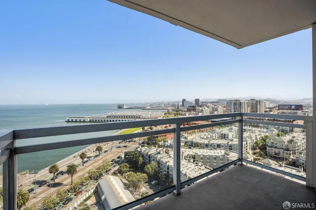 a view of a balcony with chairs potted plants