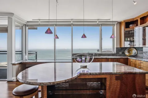 a view of a dining room with furniture a chandelier and wooden floor
