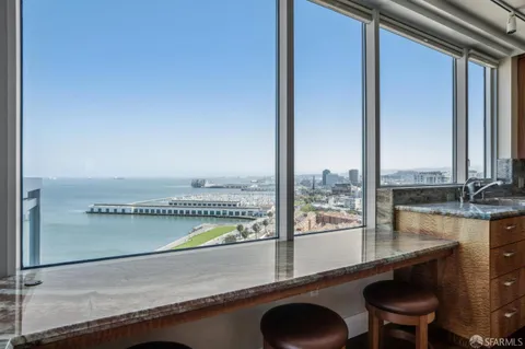 a dining room with furniture a chandelier and wooden floor