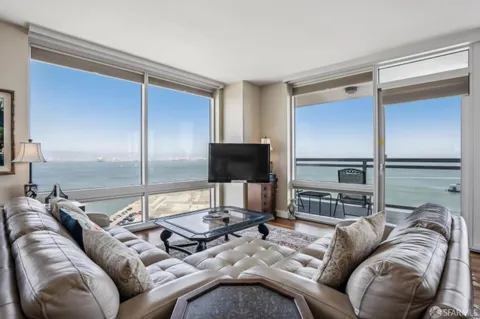 a bedroom with a bed and a view of kitchen