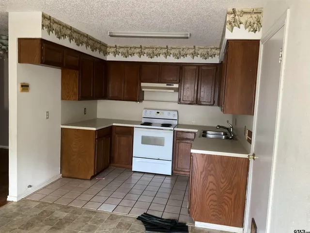 a kitchen with a stove and a refrigerator