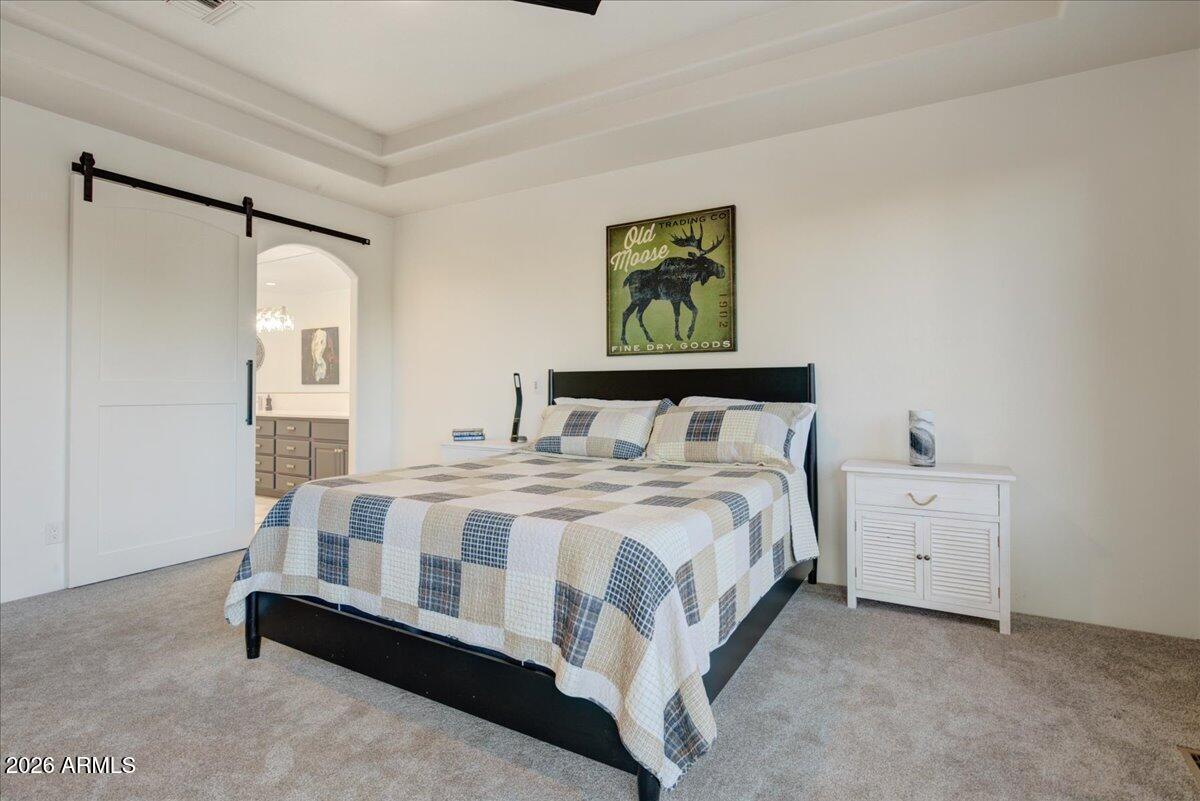 27901 Tranquilo Way Rio Verde, AZ 85263 - Photo 12 of 35 a bedroom with a bed and a painting on the wall