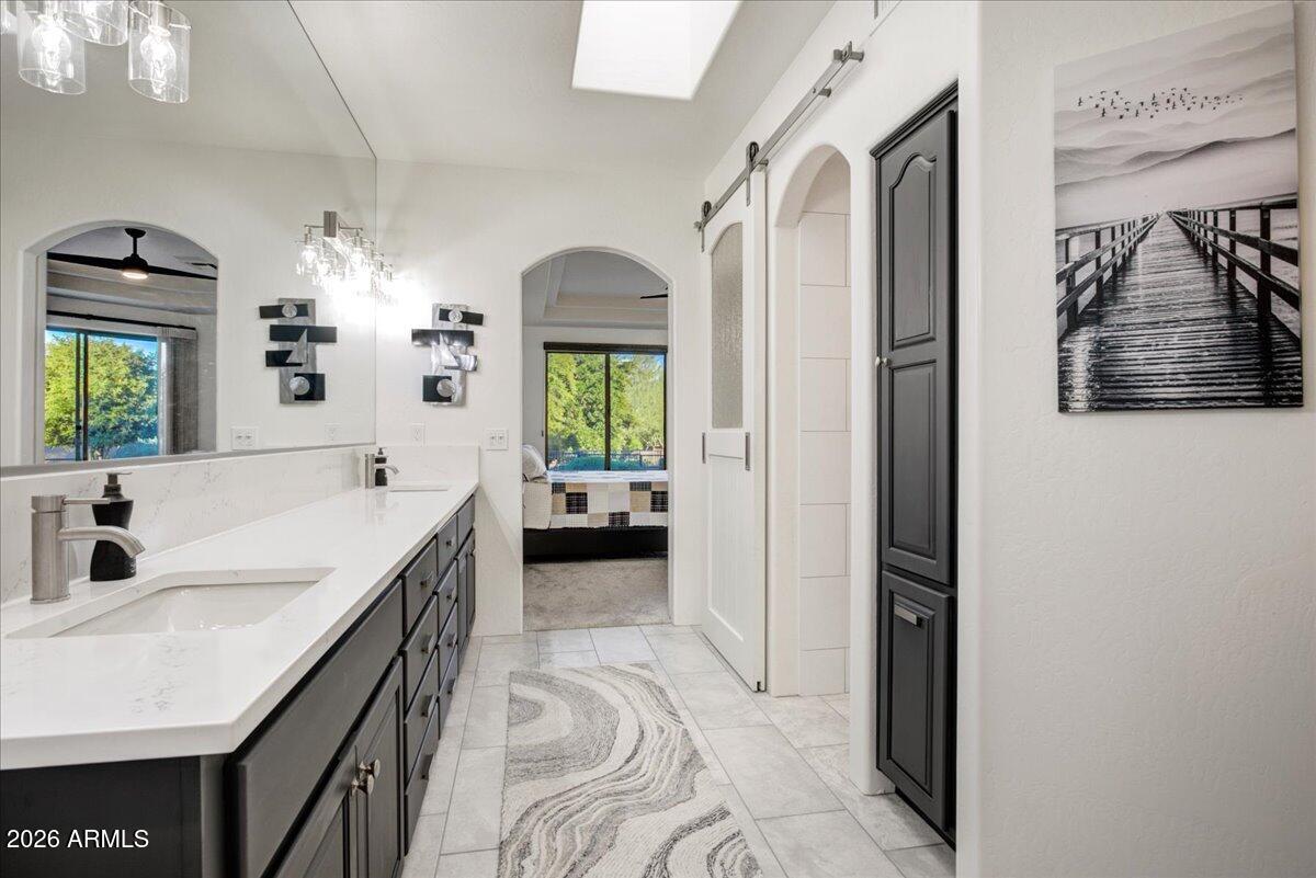 27901 Tranquilo Way Rio Verde, AZ 85263 - Photo 14 of 35 a en suite bathroom with a sink and a mirror