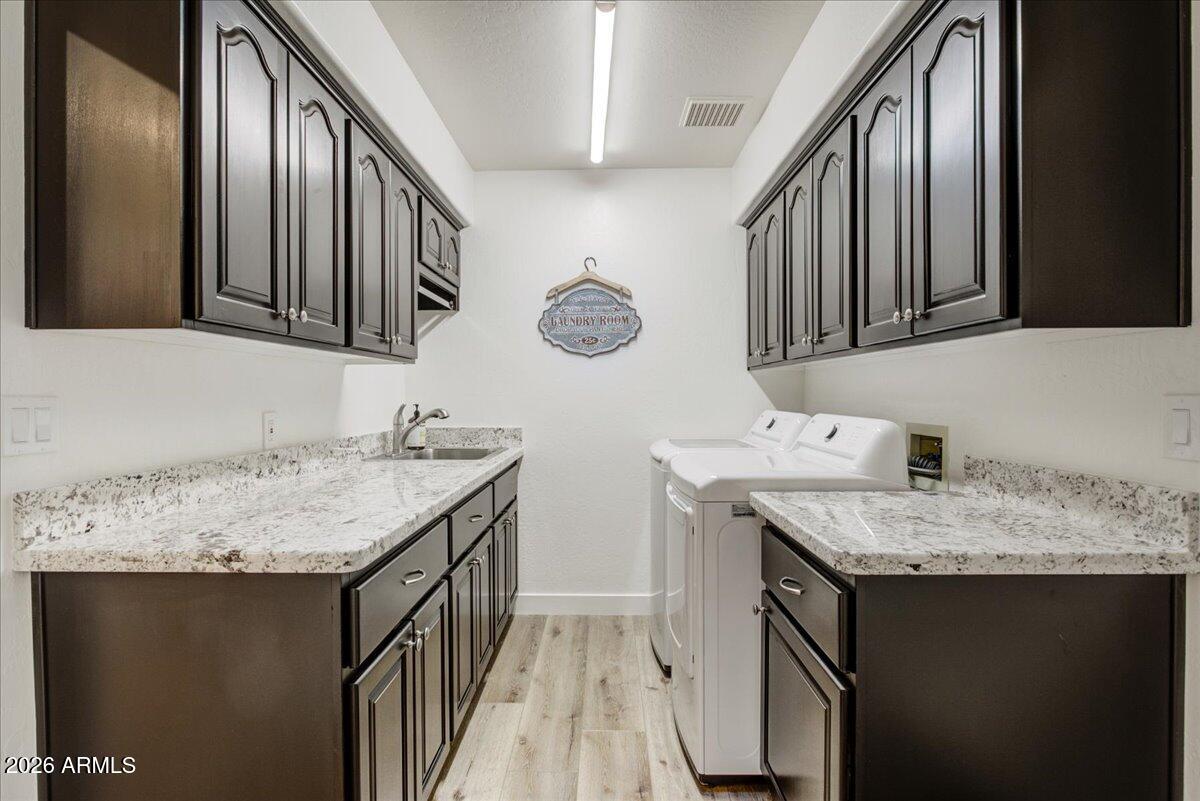 27901 Tranquilo Way Rio Verde, AZ 85263 - Photo 20 of 35 a bathroom with a granite countertop sink a vanity and a mirror