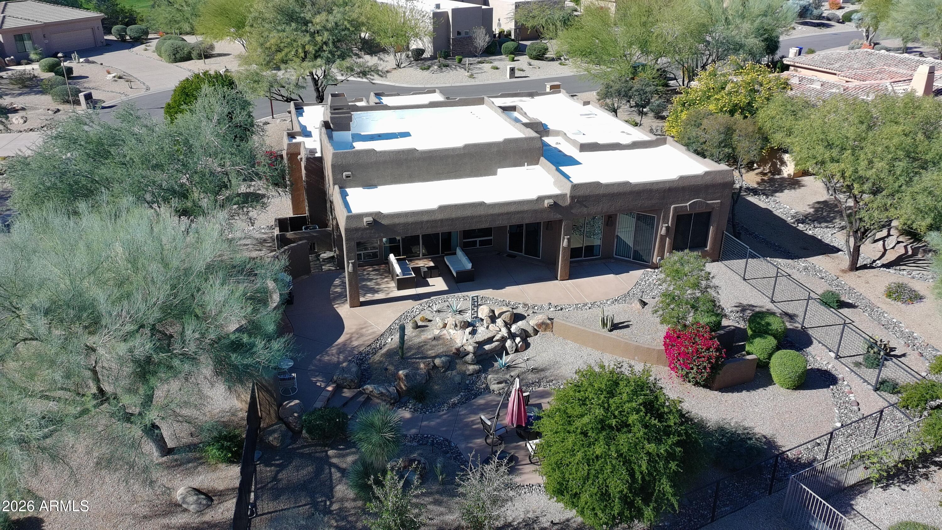 27901 Tranquilo Way Rio Verde, AZ 85263 - Photo 28 of 35 an aerial view of a house with large trees and flower plants