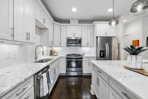 a large kitchen with a table and chairs