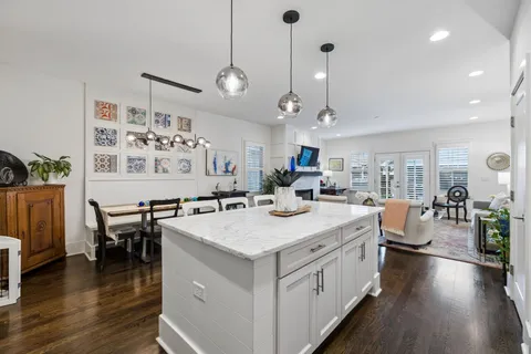 a large kitchen with a table and chairs