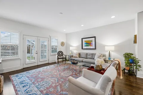 a living room with furniture and kitchen view