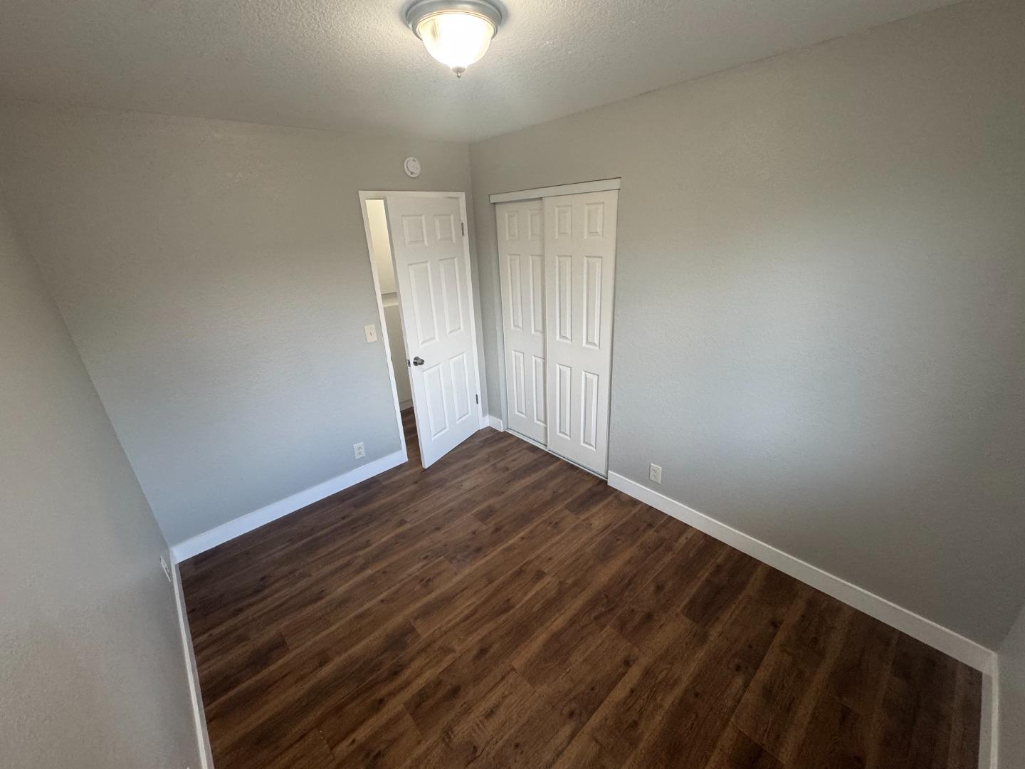 1051 Rider Avenue, Unit F Salinas, CA 93905 - Photo 16 of 23 a view of empty room with wooden floor