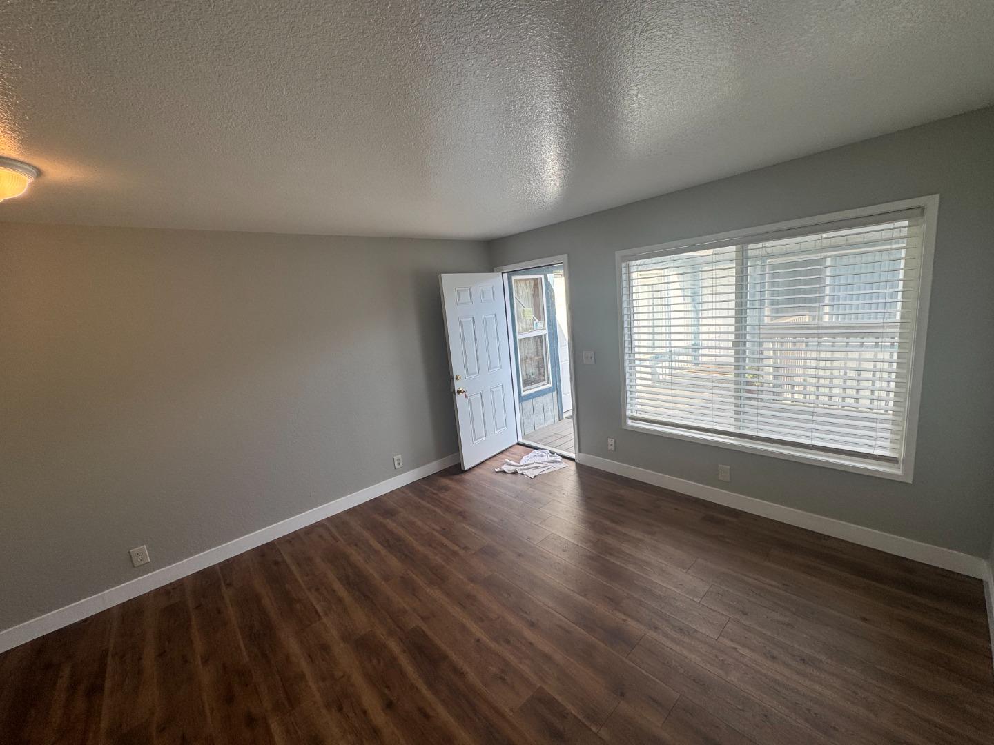 1051 Rider Avenue, Unit F Salinas, CA 93905 - Photo 20 of 23 a view of an empty room with wooden floor and a window