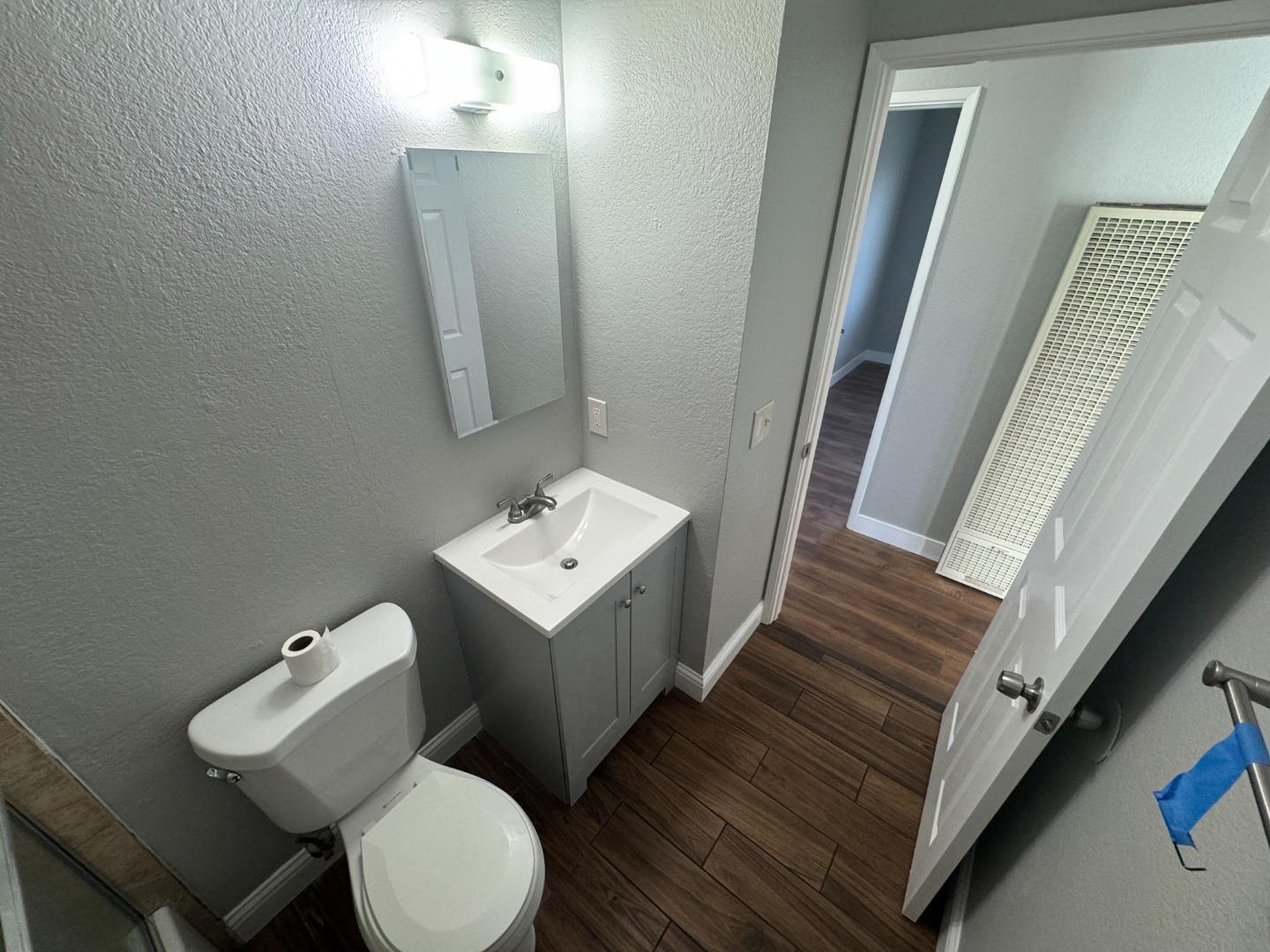1051 Rider Avenue, Unit F Salinas, CA 93905 - Photo 21 of 23 a bathroom with a toilet sink and mirror