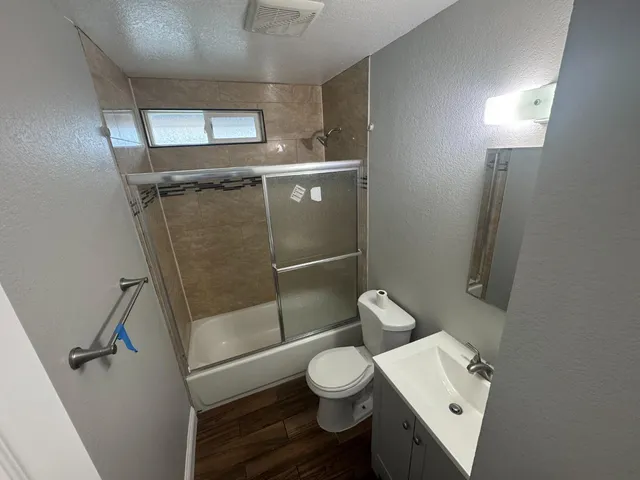a bathroom with a toilet a sink and shower