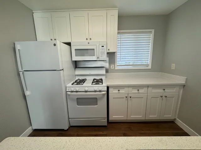 a white refrigerator freezer sitting inside of a kitchen