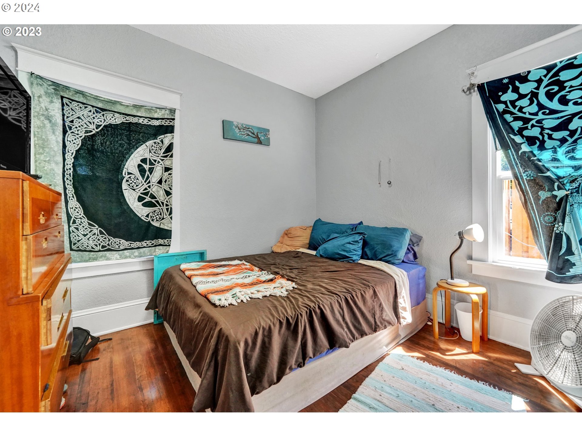 12638 Southeast Foster Road, Unit 12 Portland, OR 97236 - Photo 11 of 32 a bedroom with a bed and a painting on the wall