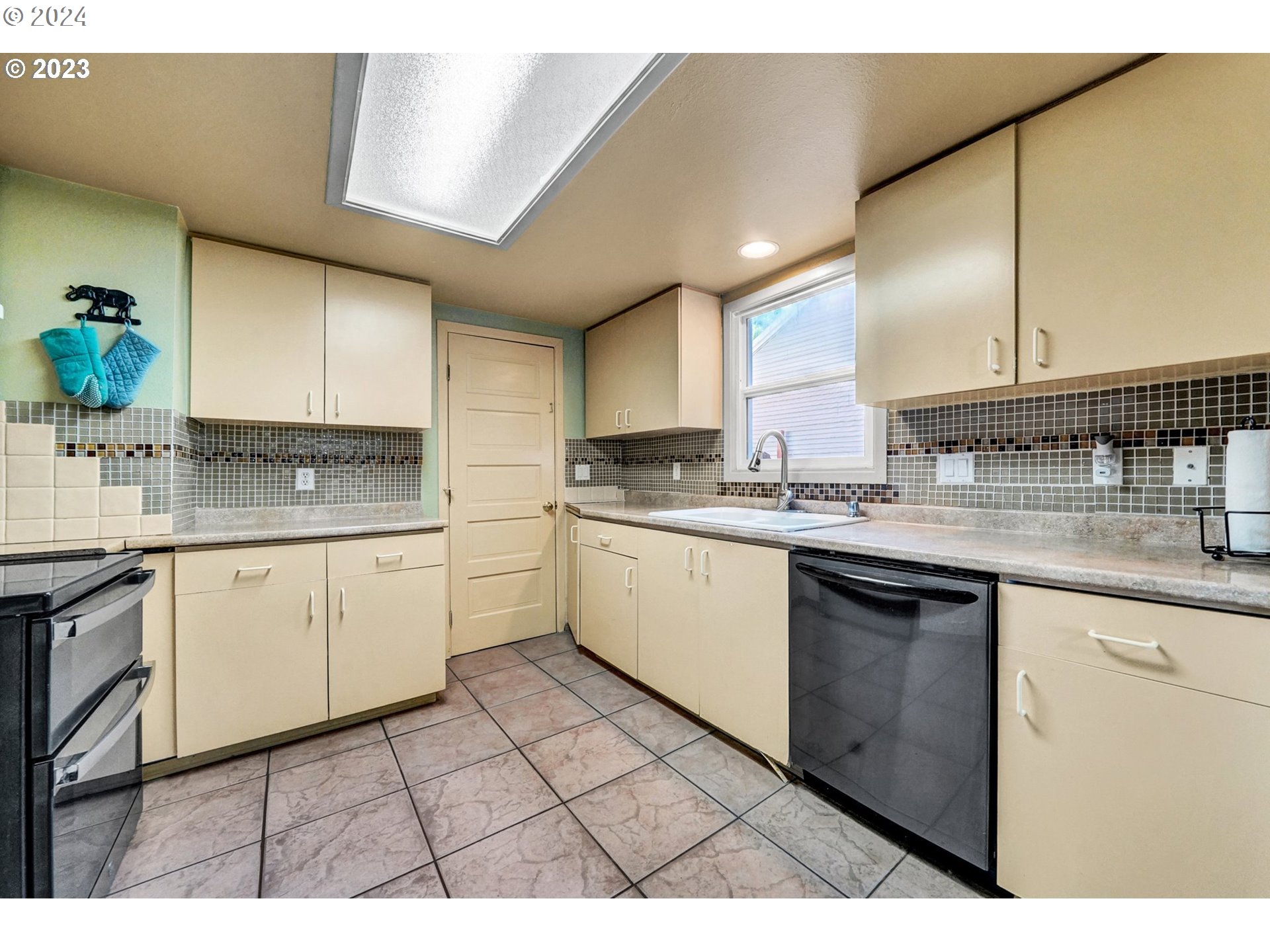 12638 Southeast Foster Road, Unit 12 Portland, OR 97236 - Photo 17 of 32 a kitchen with stainless steel appliances granite countertop a sink a stove a microwave a counter space and cabinets