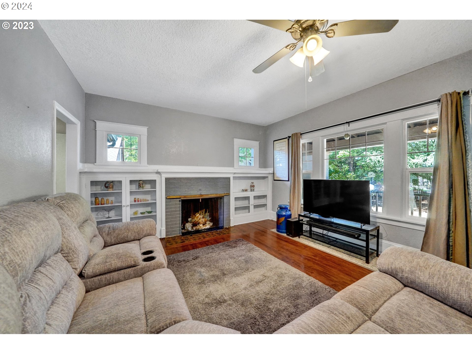 12638 Southeast Foster Road, Unit 12 Portland, OR 97236 - Photo 21 of 32 a living room with furniture a flat screen tv and a fireplace
