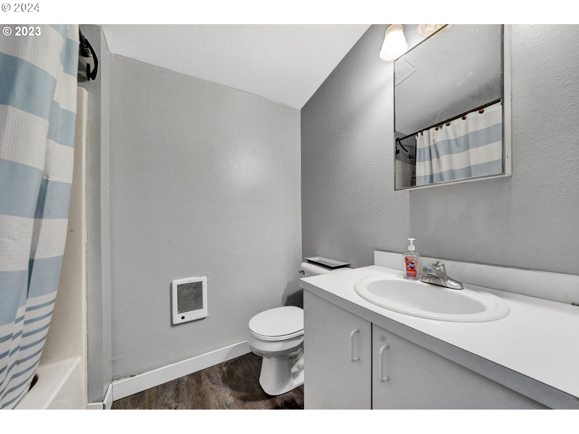 12638 Southeast Foster Road, Unit 12 Portland, OR 97236 - Photo 23 of 32 a bathroom with a sink a toilet and mirror