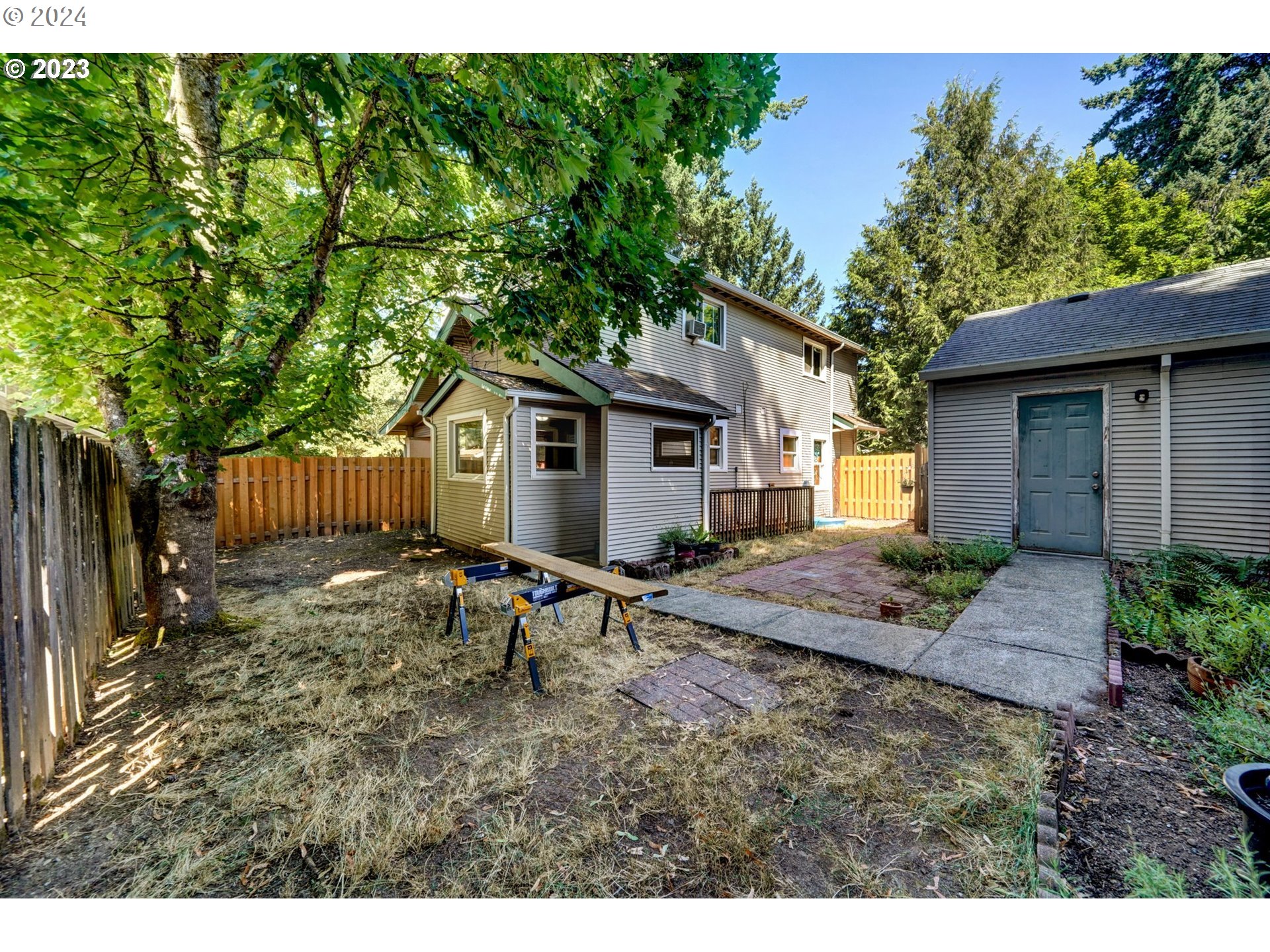 12638 Southeast Foster Road, Unit 12 Portland, OR 97236 - Photo 32 of 32 a view of a house with backyard and sitting area