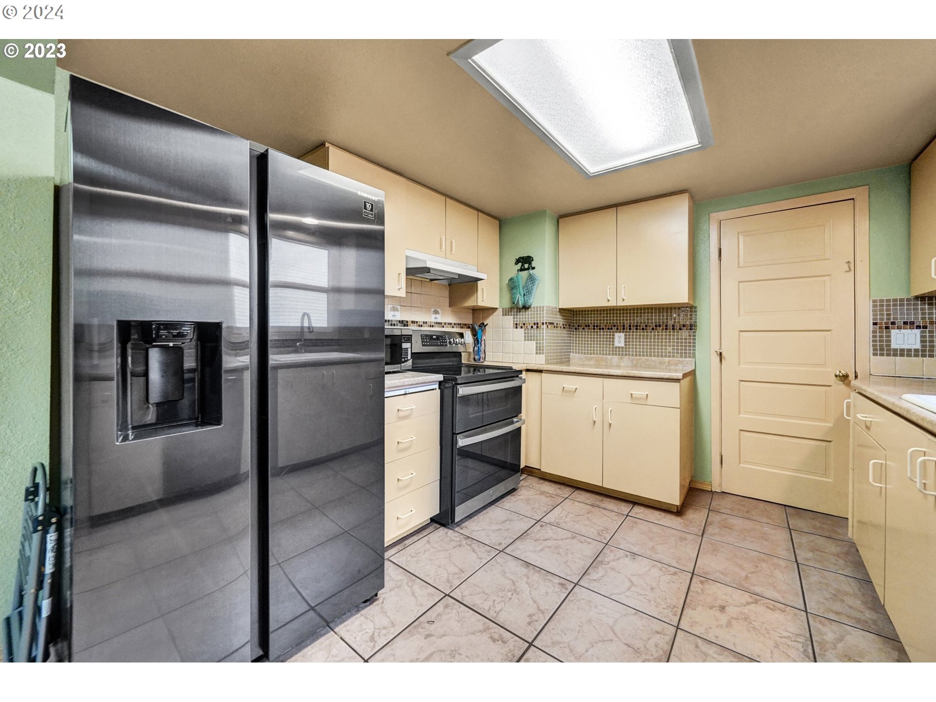 12638 Southeast Foster Road, Unit 12 Portland, OR 97236 - Photo 6 of 32 a kitchen with stainless steel appliances granite countertop a refrigerator sink and cabinets