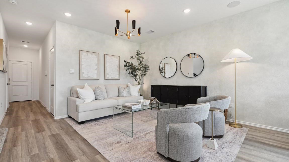 a living room with furniture a fireplace and a flat screen tv