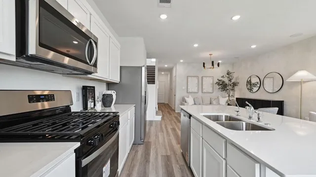 a kitchen with a sink stainless steel appliances and cabinets