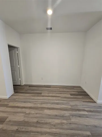 a view of an empty room and wooden floor