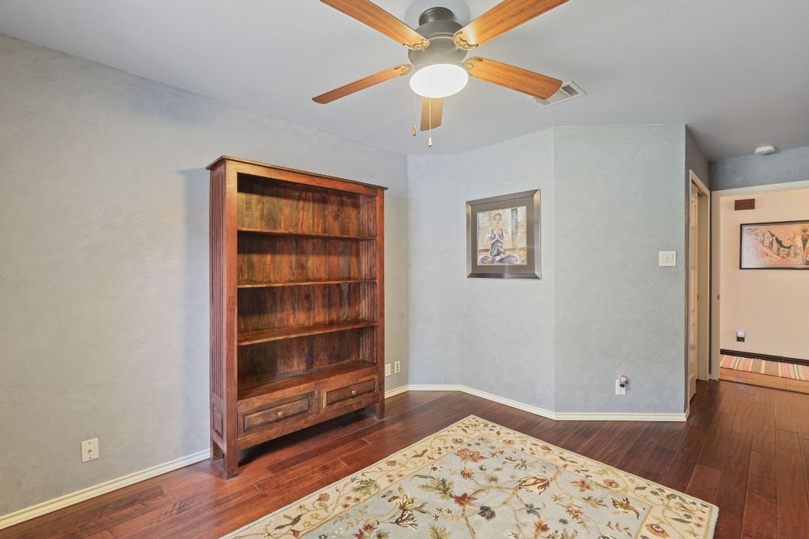 2114 Desco Drive Austin, TX 78748 - Photo 15 of 40 Living area with hardwood / wood-style floors, a ceiling fan, and baseboards