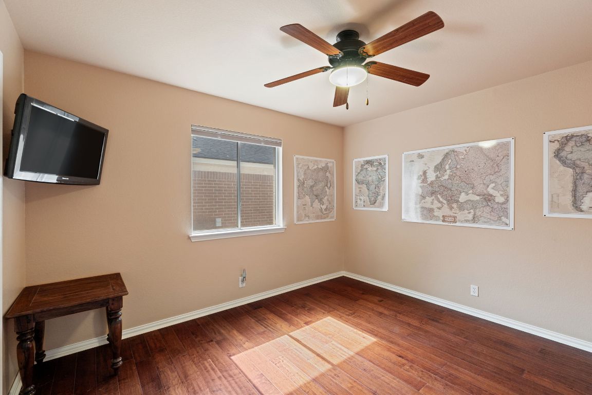 2114 Desco Drive Austin, TX 78748 - Photo 18 of 40 Spare room with ceiling fan, wood finished floors, and baseboards