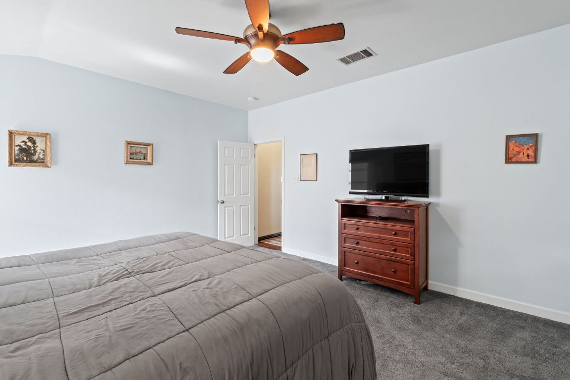 2114 Desco Drive Austin, TX 78748 - Photo 32 of 40 Carpeted bedroom with ceiling fan and baseboards
