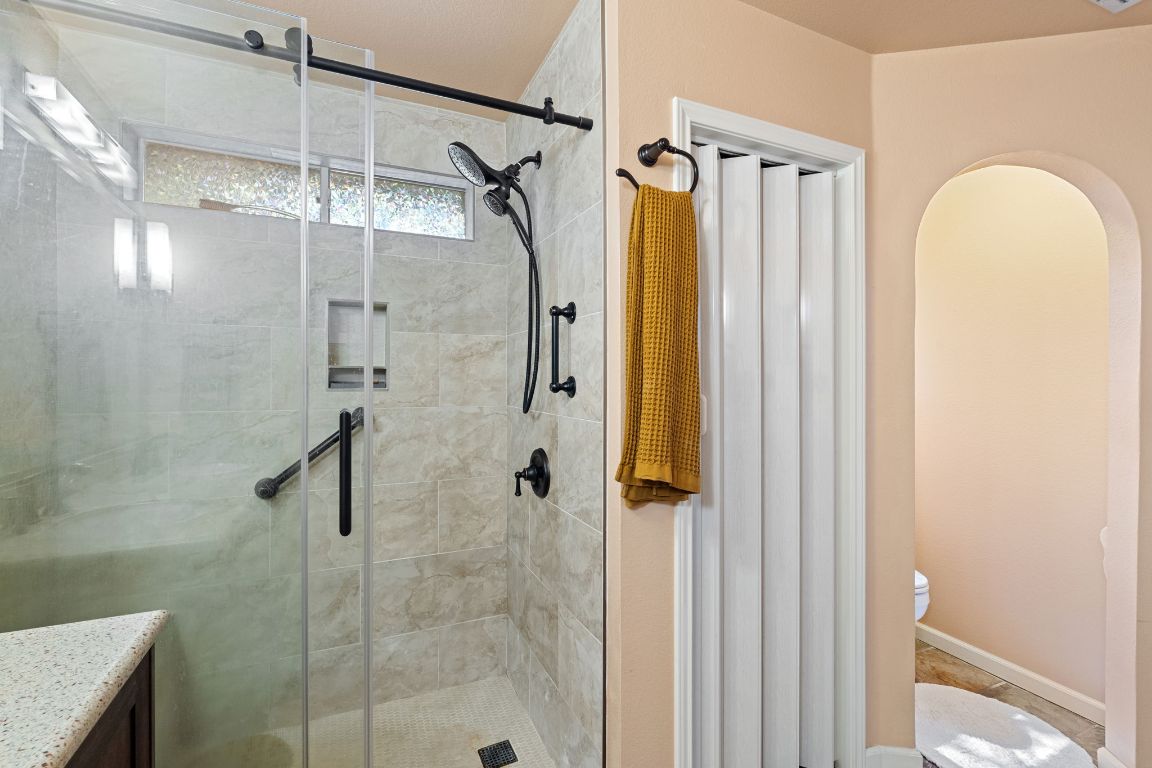 2114 Desco Drive Austin, TX 78748 - Photo 35 of 40 Bathroom featuring toilet, a shower stall, and vanity