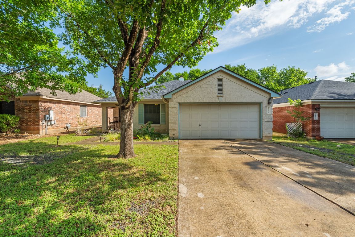 2114 Desco Drive Austin, TX 78748 - Photo 36 of 40 Ranch-style home featuring brick siding, driveway, an attached garage, and a front yard