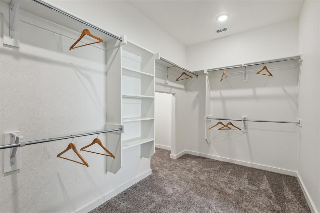 1129 Del Rio Drive Lavon, TX 75166 - Photo 20 of 28 Primary Closet in the Wimbledon home plan by Trophy Signature Homes – REPRESENTATIVE PHOTO