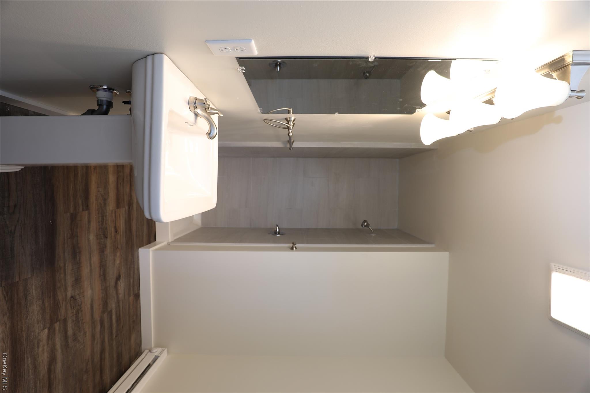 14311 Rte 9W, Unit 2 Ravena, NY 12143 - Photo 6 of 9 a bathroom with a sink and a mirror