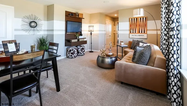 a living room with furniture and a chandelier