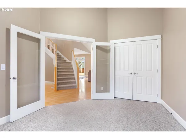 a view of empty room with wooden floor