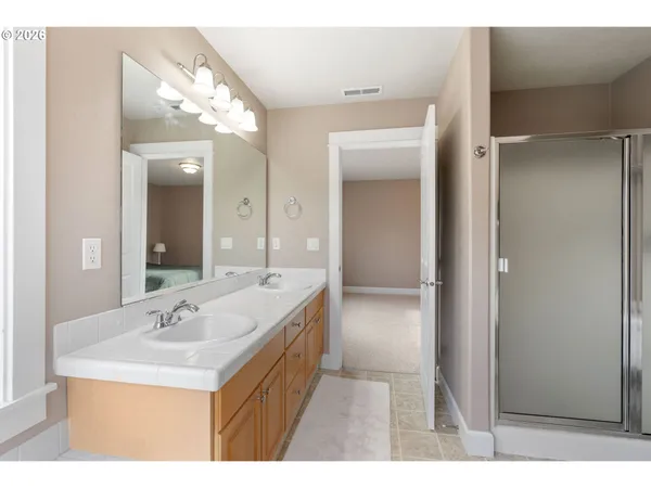 a bathroom with a sink a mirror and a shower