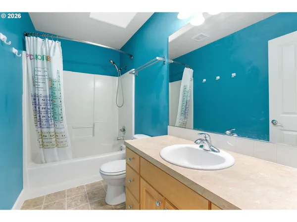 a bathroom with a sink toilet a mirror and shower