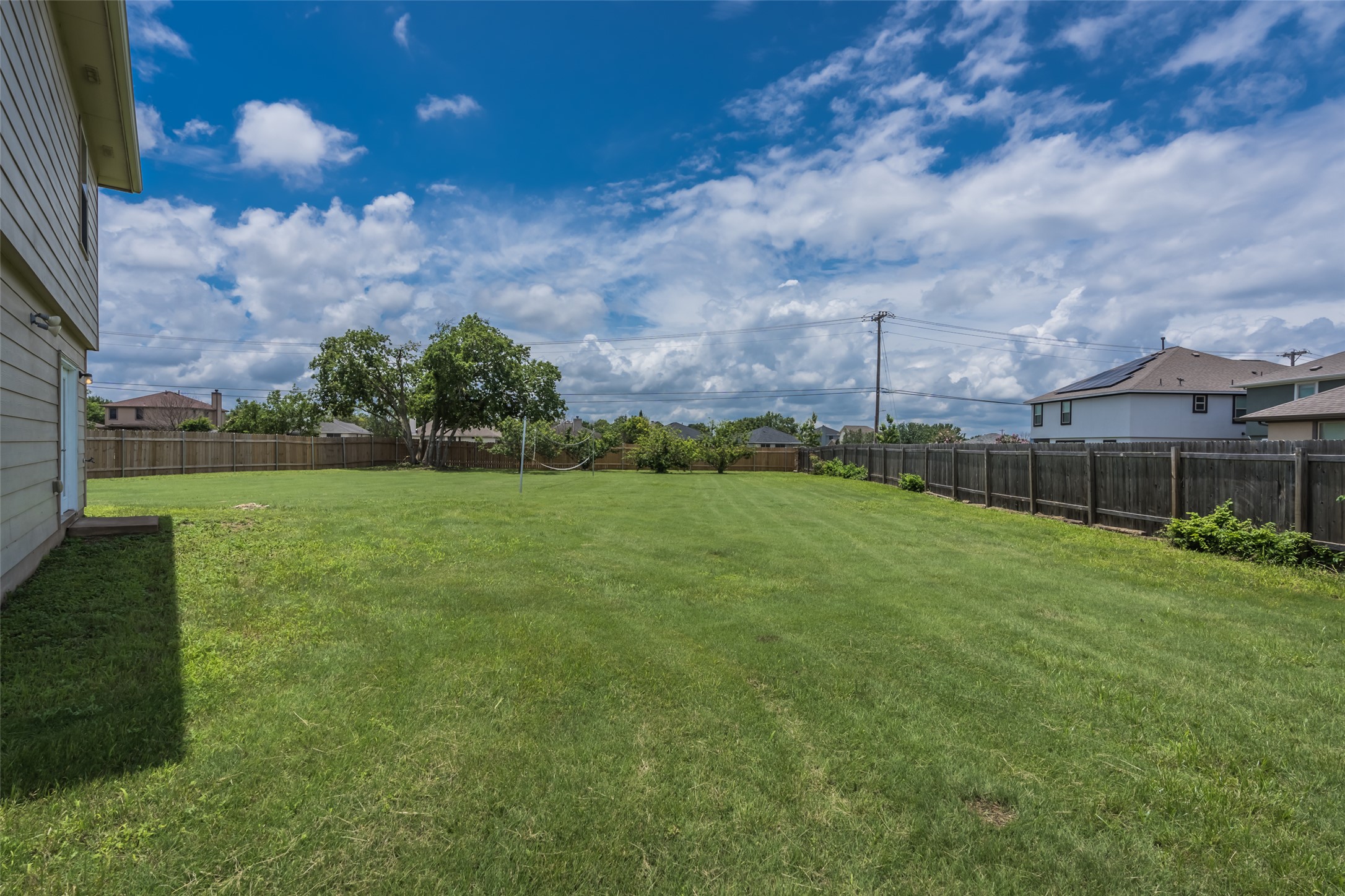 1013 Ranchero Road Leander, TX 78641 - Photo 27 of 30 A spacious backyard comes fully enclosed by a tall privacy fence.