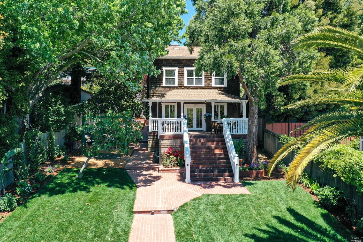 a view of a house with backyard sitting area and garden