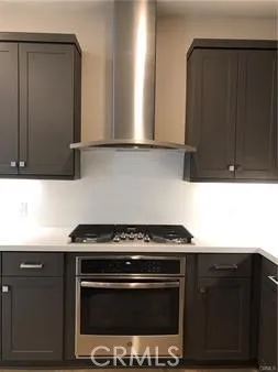 a kitchen with granite countertop a stove and a microwave