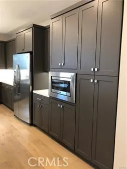 a kitchen with granite countertop a refrigerator and a sink