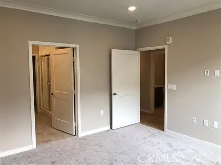 an empty room with closet and a bathroom
