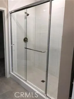 a bathroom with a glass shower door