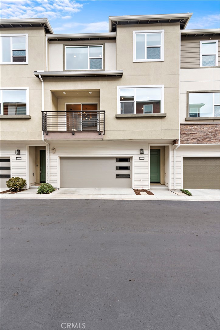 a front view of a house with a road
