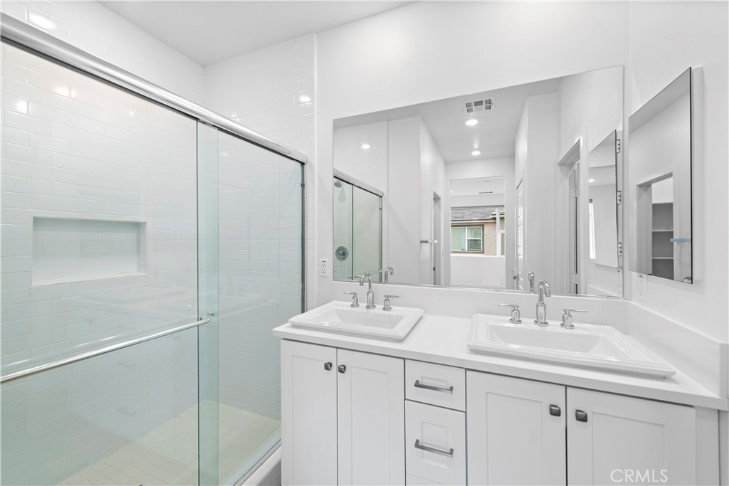 235 Carmona Lake Forest, CA 92630 - Photo 11 of 21 a bathroom with a double vanity sink and mirror