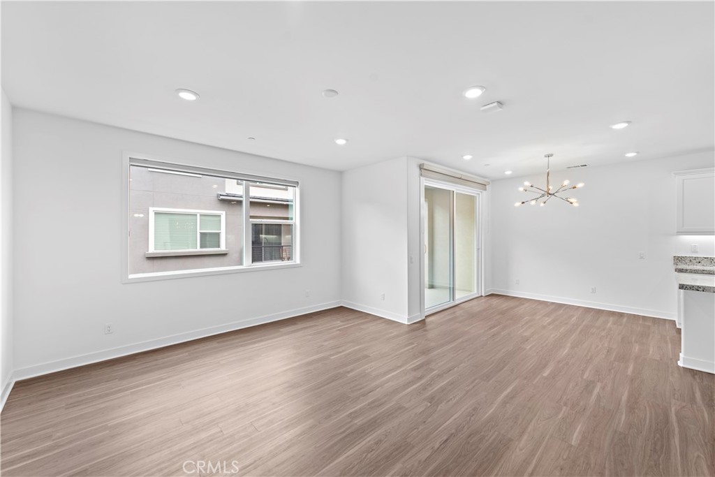 235 Carmona Lake Forest, CA 92630 - Photo 3 of 21 a view of an empty room with wooden floor and a window