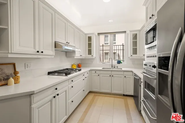 a kitchen with a sink stove and refrigerator