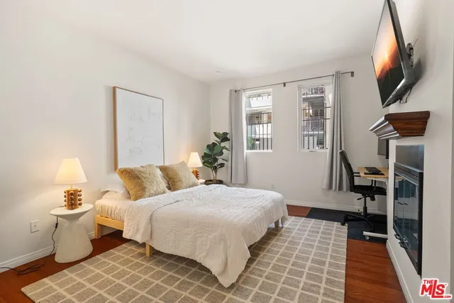 a bedroom with a bed and a flat screen tv