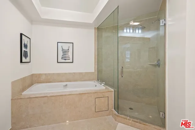 a bathroom with a bathtub and shower